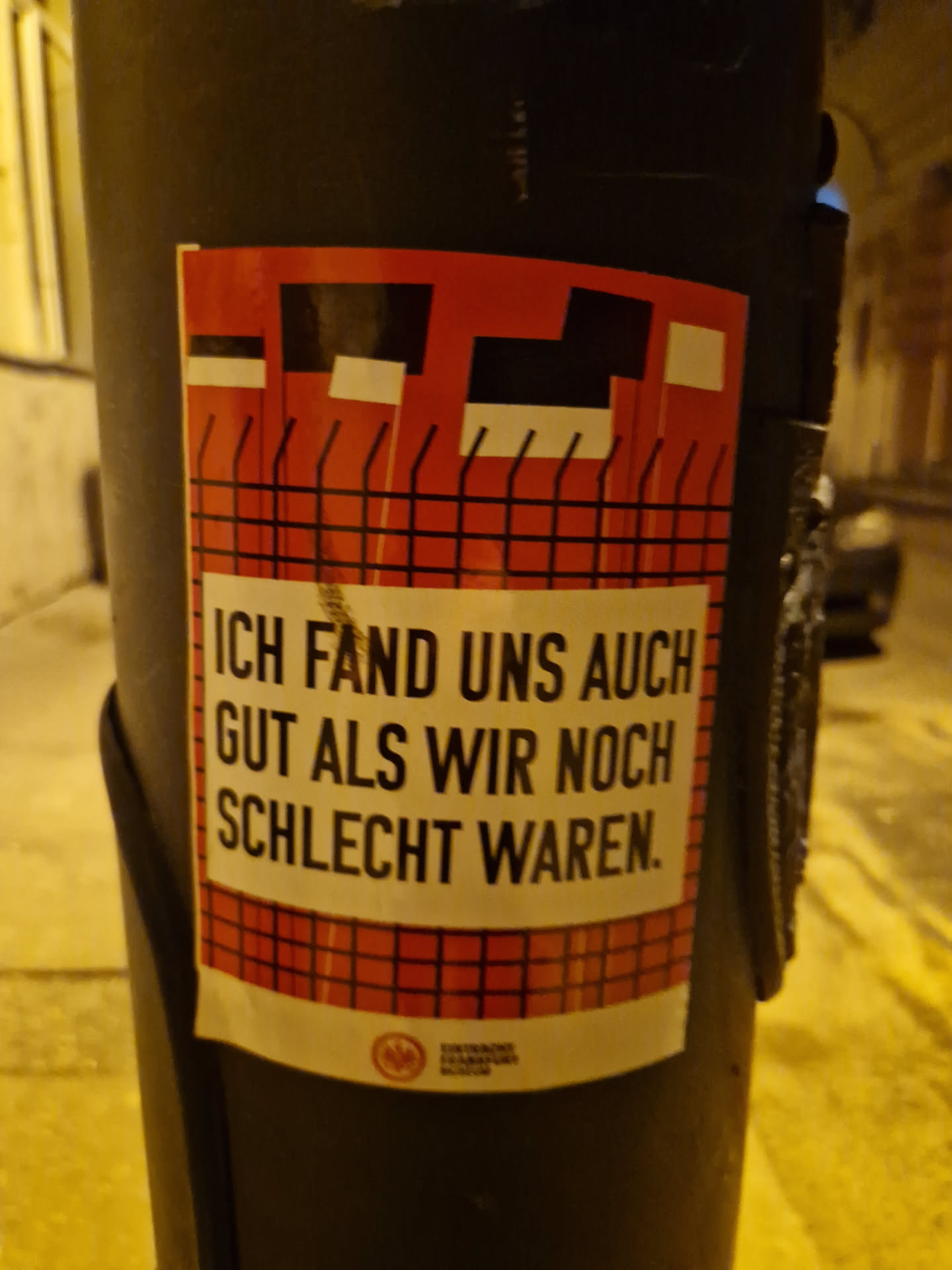 A sticker with a red and black design and German text. The text translates to: "I also found us good when we were still bad."
