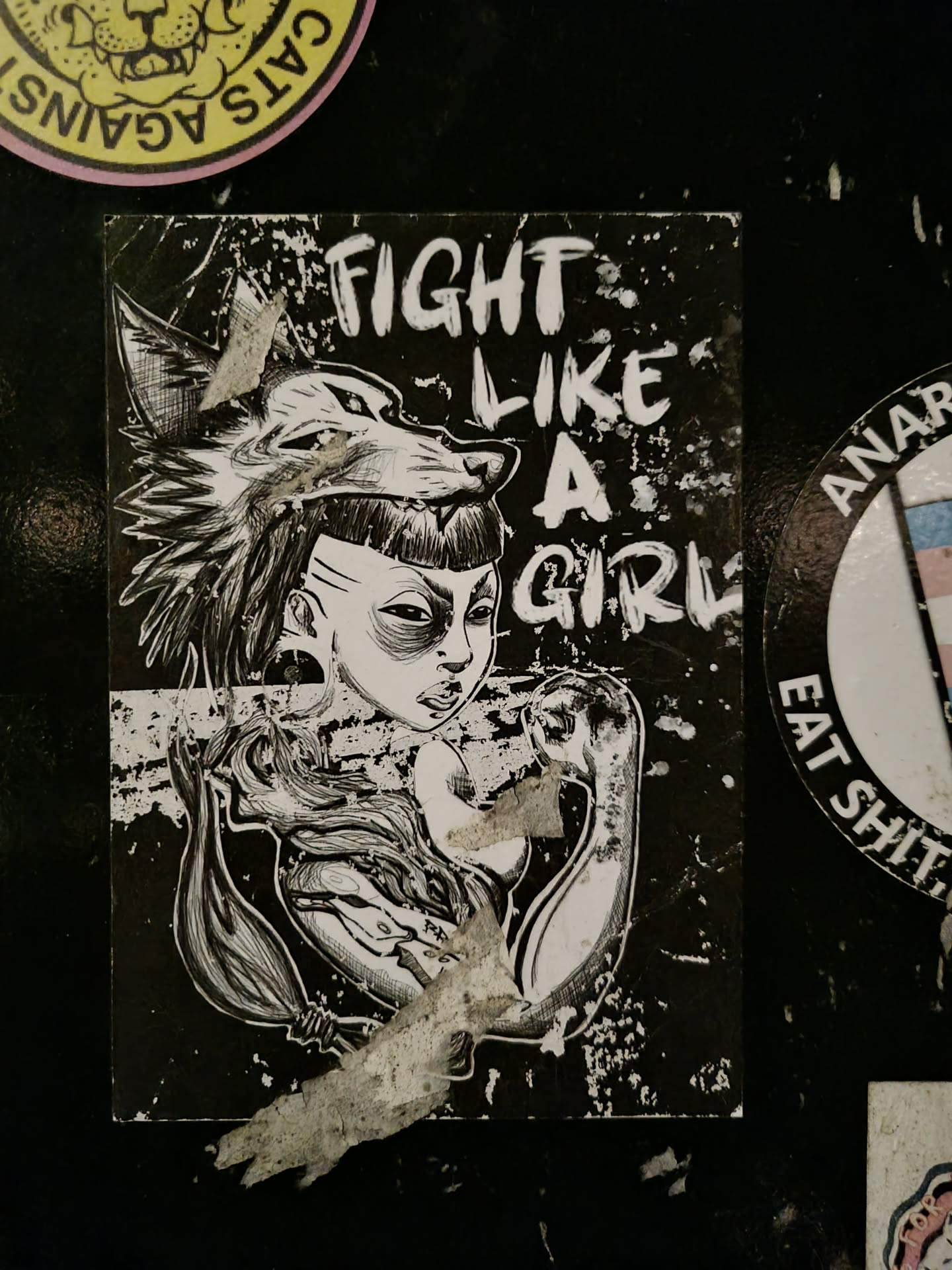 Black and white sticker featuring a girl with a wolf head and the text "Fight Like A Girl".