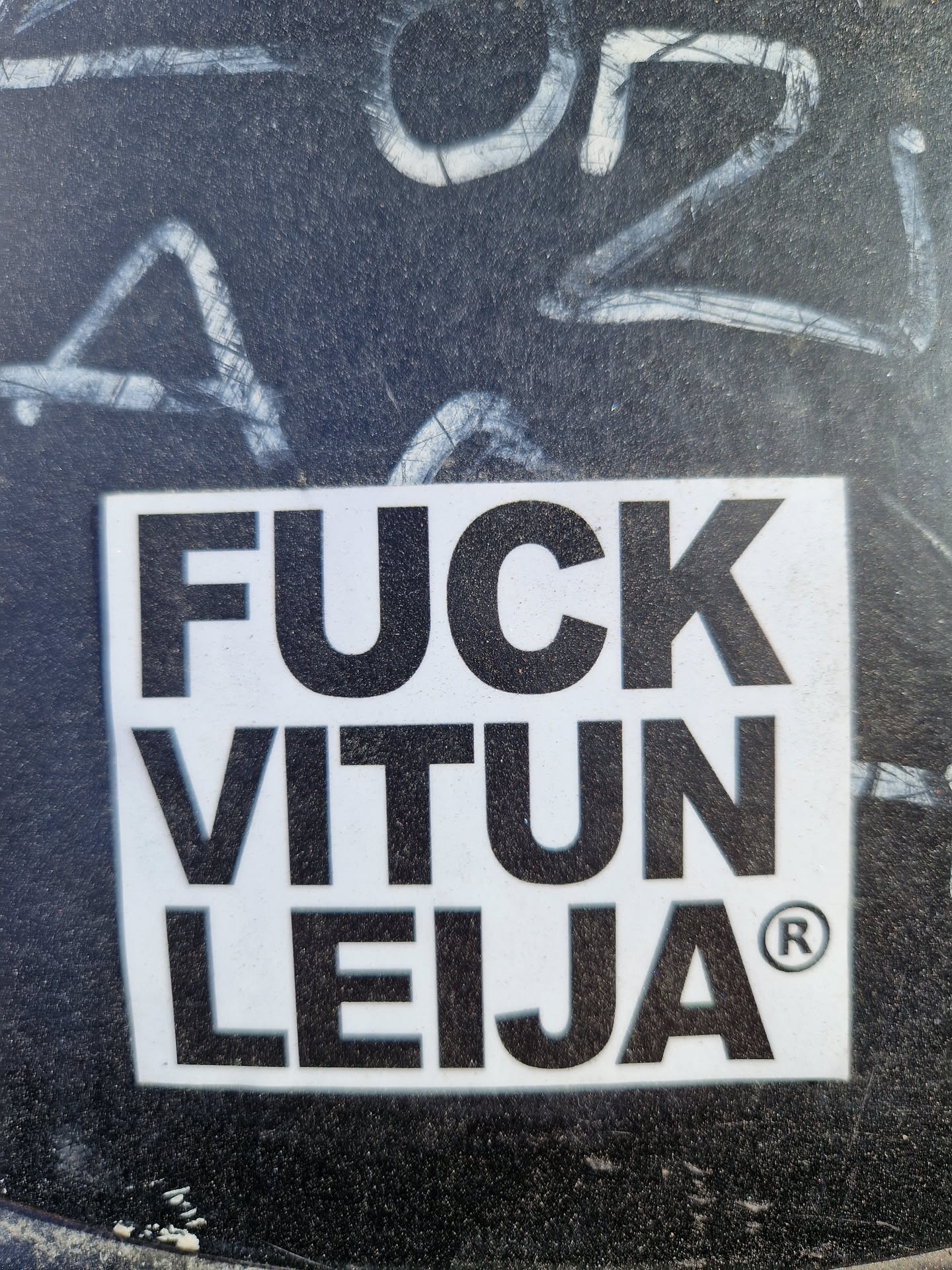 A square white sticker with black bold text.  The text says "FUCK VITUN LEIJA" with a registered trademark symbol. The phrase is offensive. 