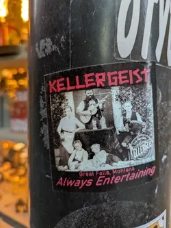 A black and white photo of a family band, possibly the Kellergeist, with the band's name and location printed on the sticker.