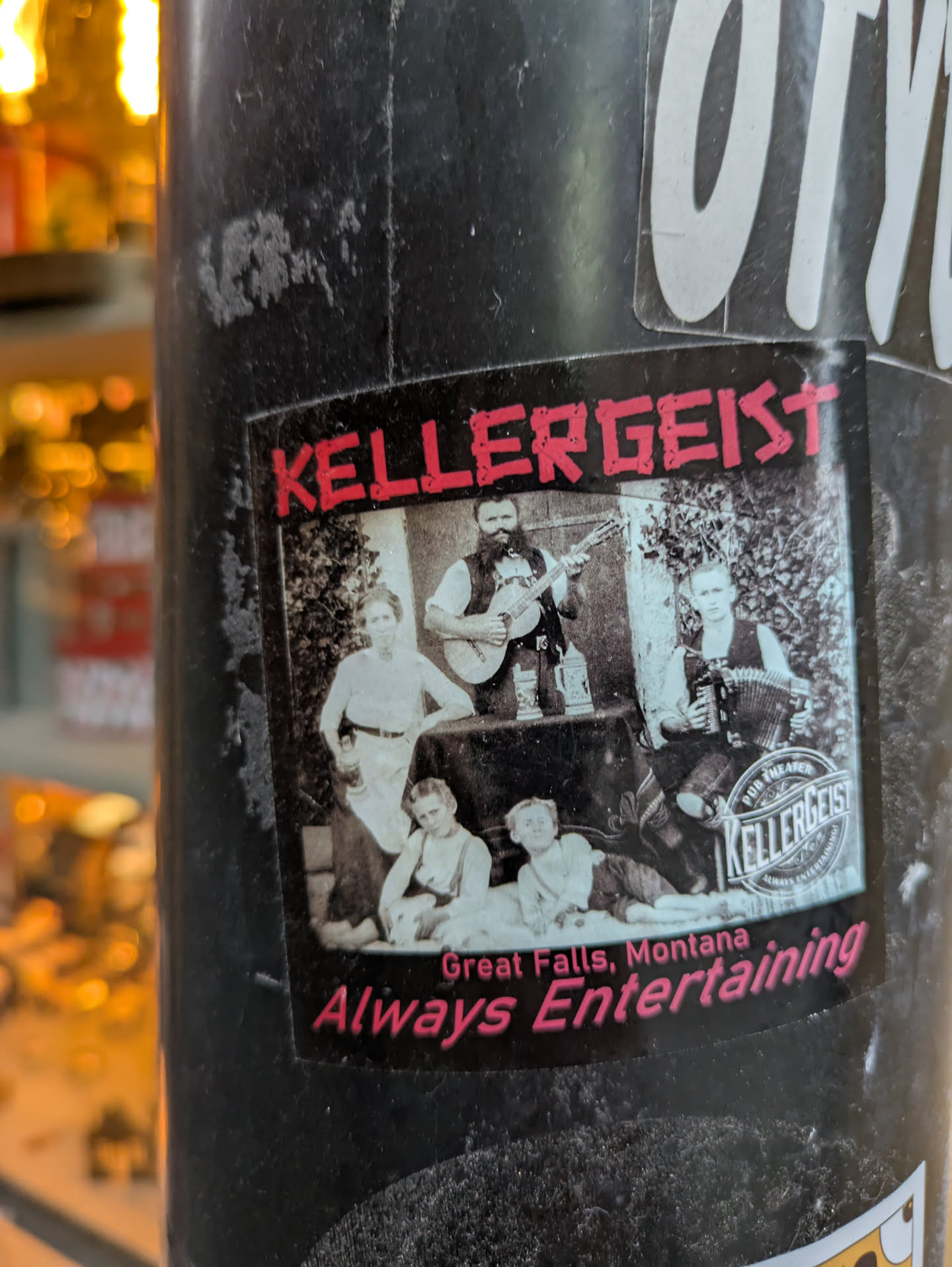 A black and white photo of a family band, possibly the Kellergeist, with the band's name and location printed on the sticker.