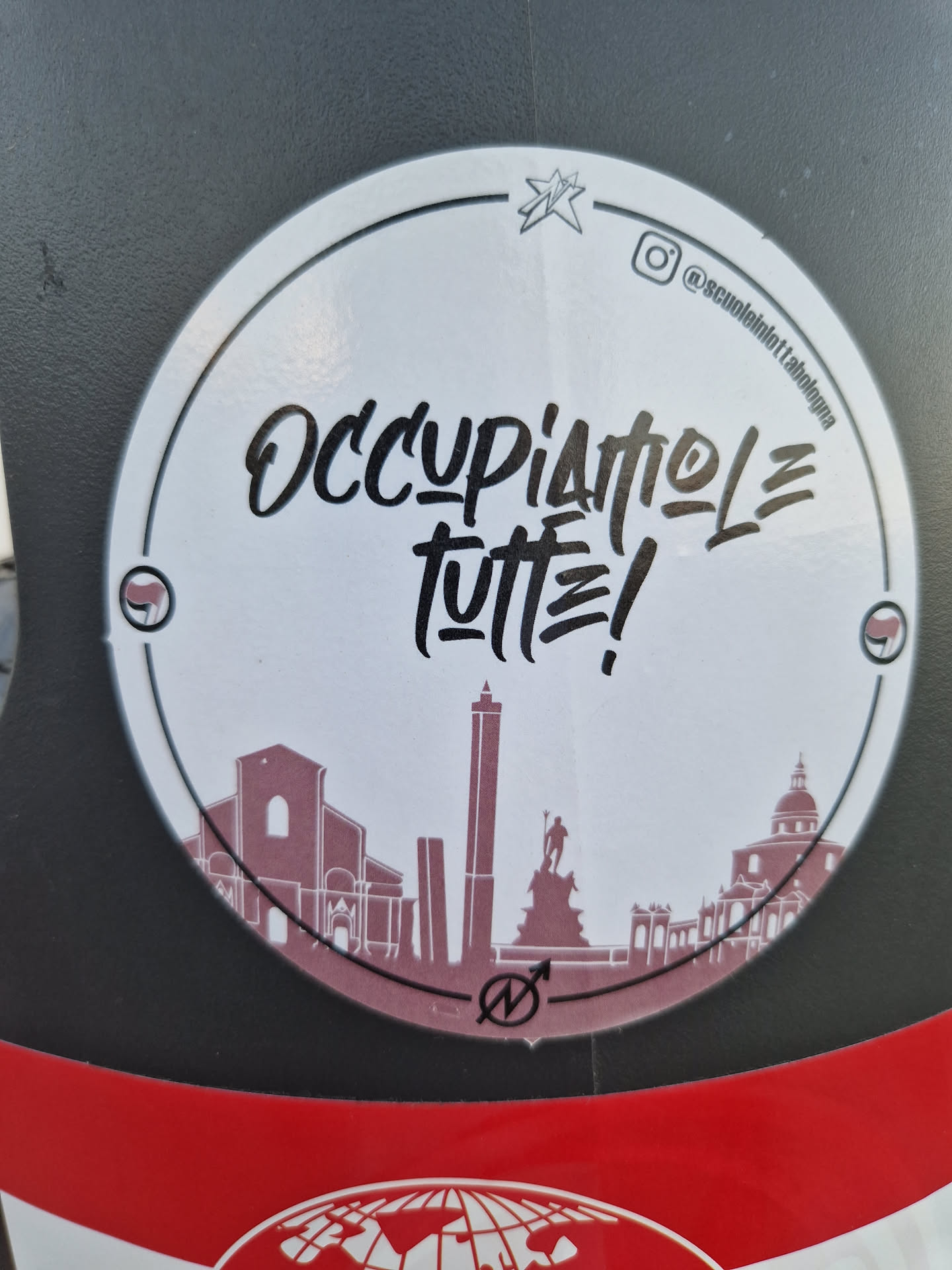 Round sticker with the text "Occupiamo le tutte!" in a stylized font.  It also features a simple line drawing of a cityscape, possibly Palermo, and a small logo. An Instagram handle is visible in the upper right corner.