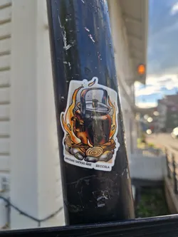 This sticker features a detailed illustration of a kettle sitting on a bonfire. The style is reminiscent of traditional tattoo art. The sticker includes the text "ARYONE TATTOO ARE" and "BEOCSLA", indicating the artist or studio's name and possibly location.