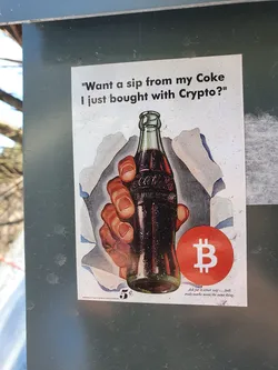 A sticker featuring a vintage Coca-Cola advertisement with a Bitcoin symbol overlaid. The text on the sticker reads, "Want a sip from my Coke I just bought with Crypto?"
