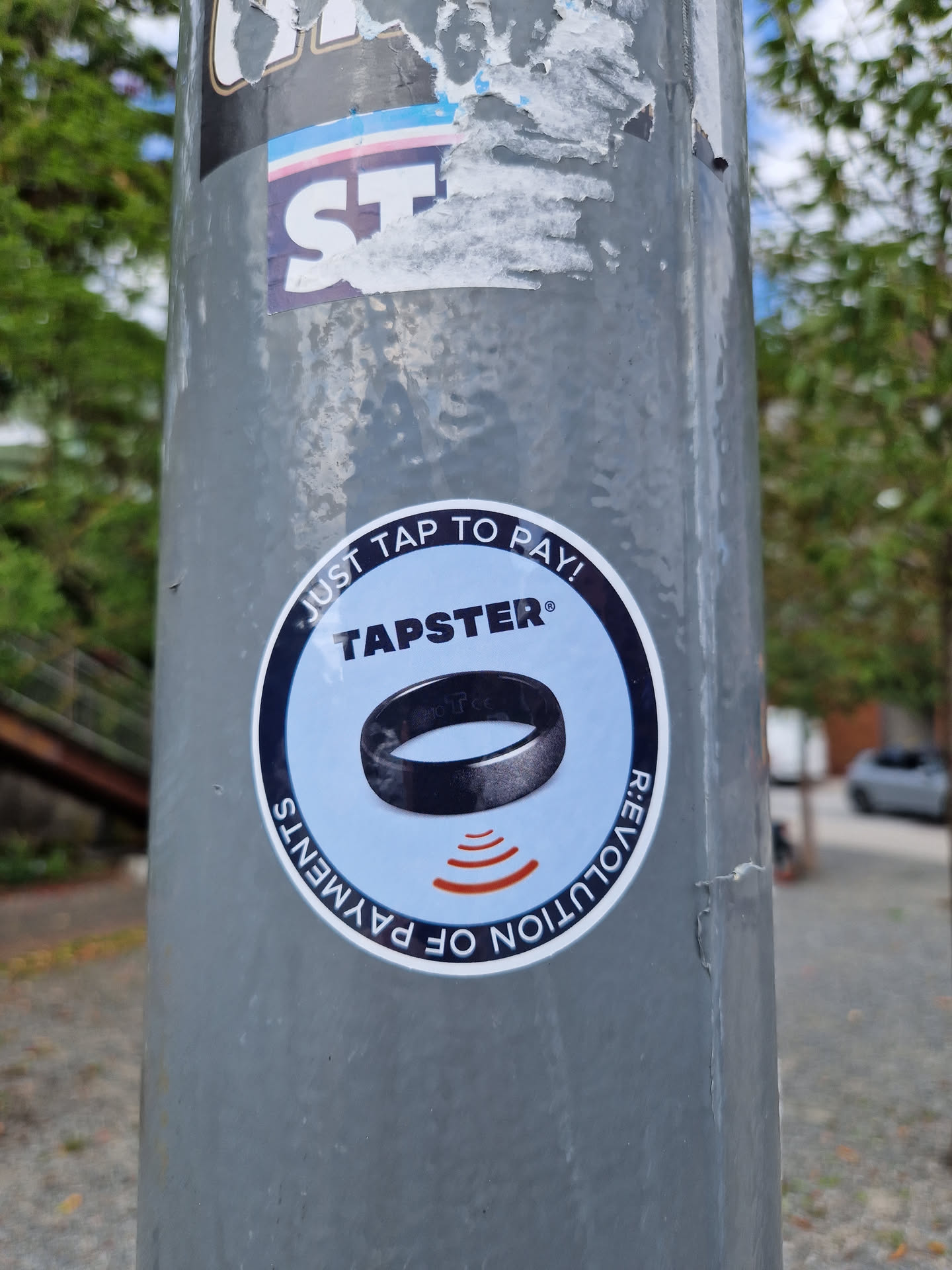 A Tapster sticker on a pole. Tapster is a contactless payment system.