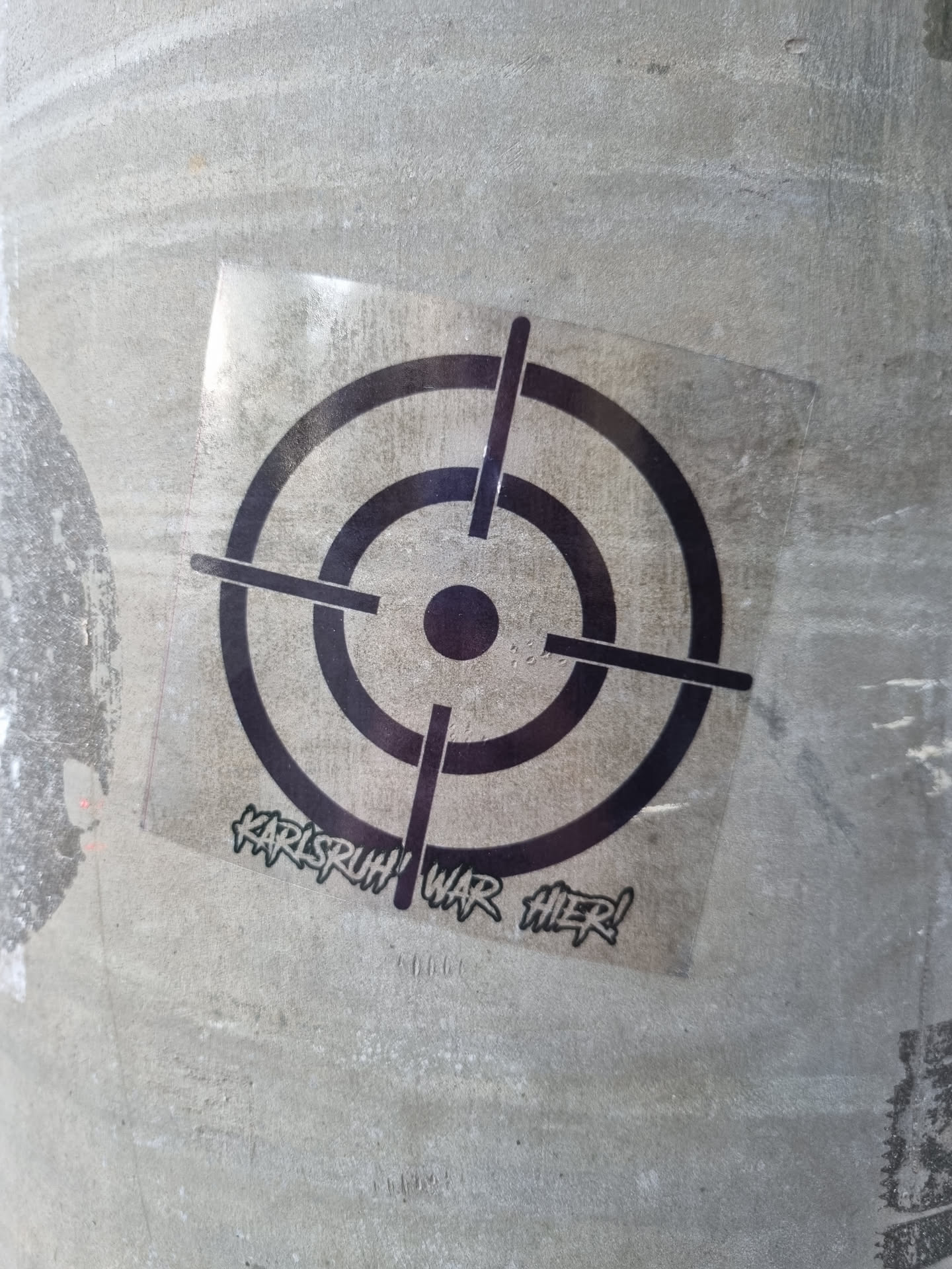 A black and white sticker with a target graphic and the text 'Karlsruhe war hier!' (Karlsruhe was here!).