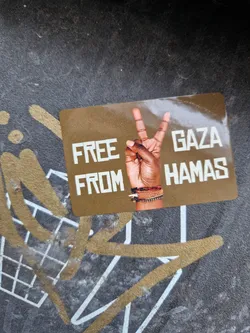 A sticker with a peace sign and the text "Free Gaza from Hamas". The background is gold and the text is white.