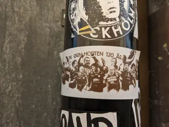 Sepia-toned sticker commemorating the 120th anniversary of FK Örn Horten. It features a group photograph of football players, likely from the team, in a celebratory pose.