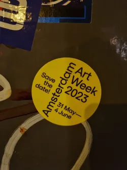 Street sticker Round yellow sticker announcing the Amsterdam Art Week 2023, taking place from May 31st to June 4th.  The sticker has the text 'Save the date!' above the event details.