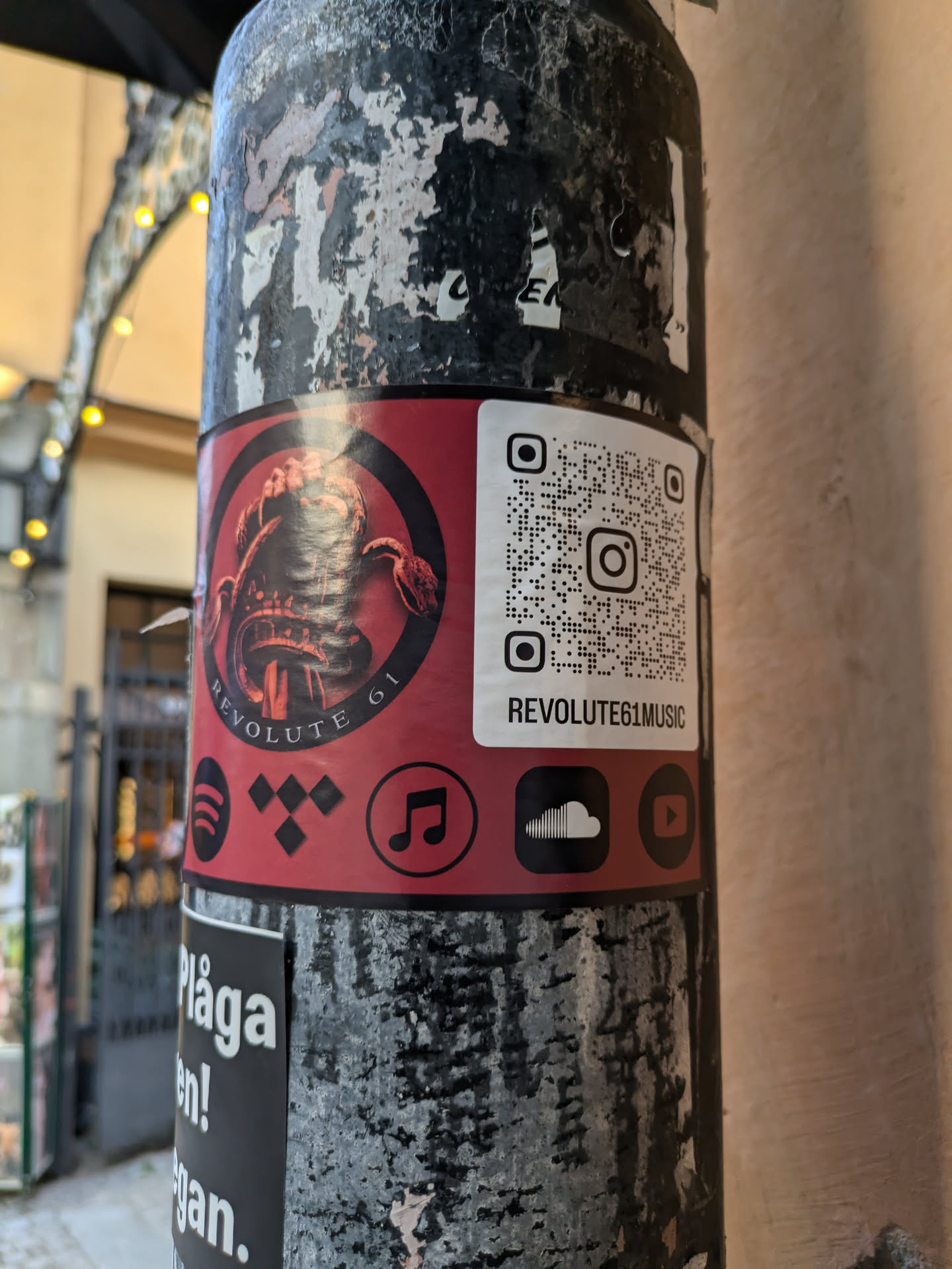 Sticker featuring a scorpion design and links to various music platforms. QR code links to Instagram.