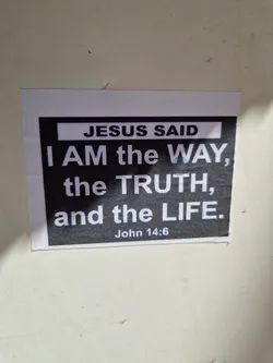 A religious sticker with a quote from John 14:6. The sticker has a black background with white text.