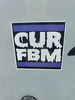 A sticker with the text "CUR FBM" in a dripping style font. The text is white on a black background, with a purple stripe at the top and bottom. 