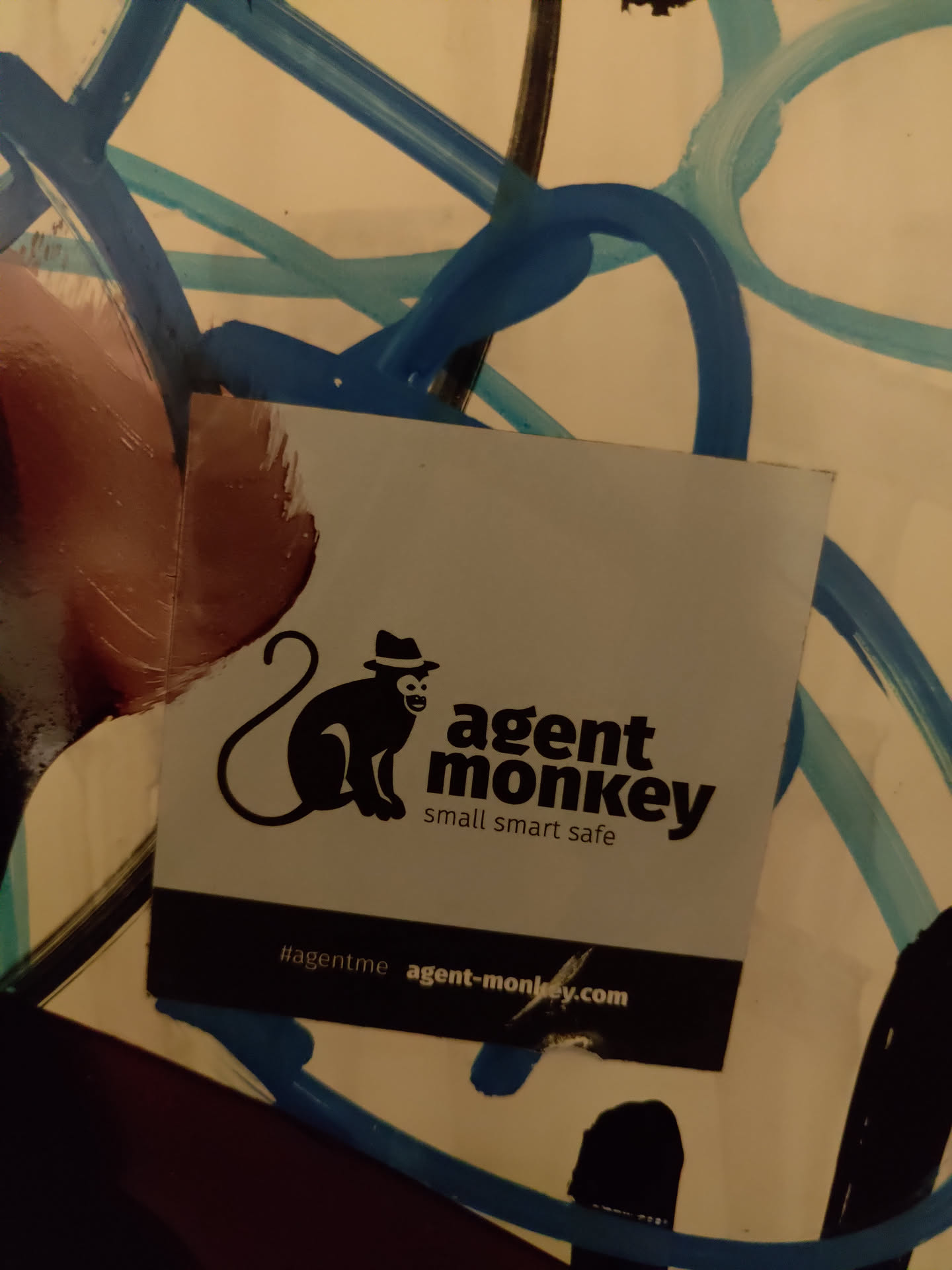 A sticker featuring a monkey wearing a hat, with the text 'agent monkey' and the tagline 'small smart safe'.  A website address and hashtag are also included.