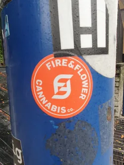 Round orange sticker with the Fire & Flower Cannabis Co. logo and text.  The logo is a stylized 'FF' in white. The text says "FIRE & FLOWER" above the logo and "CANNABIS CO." below.