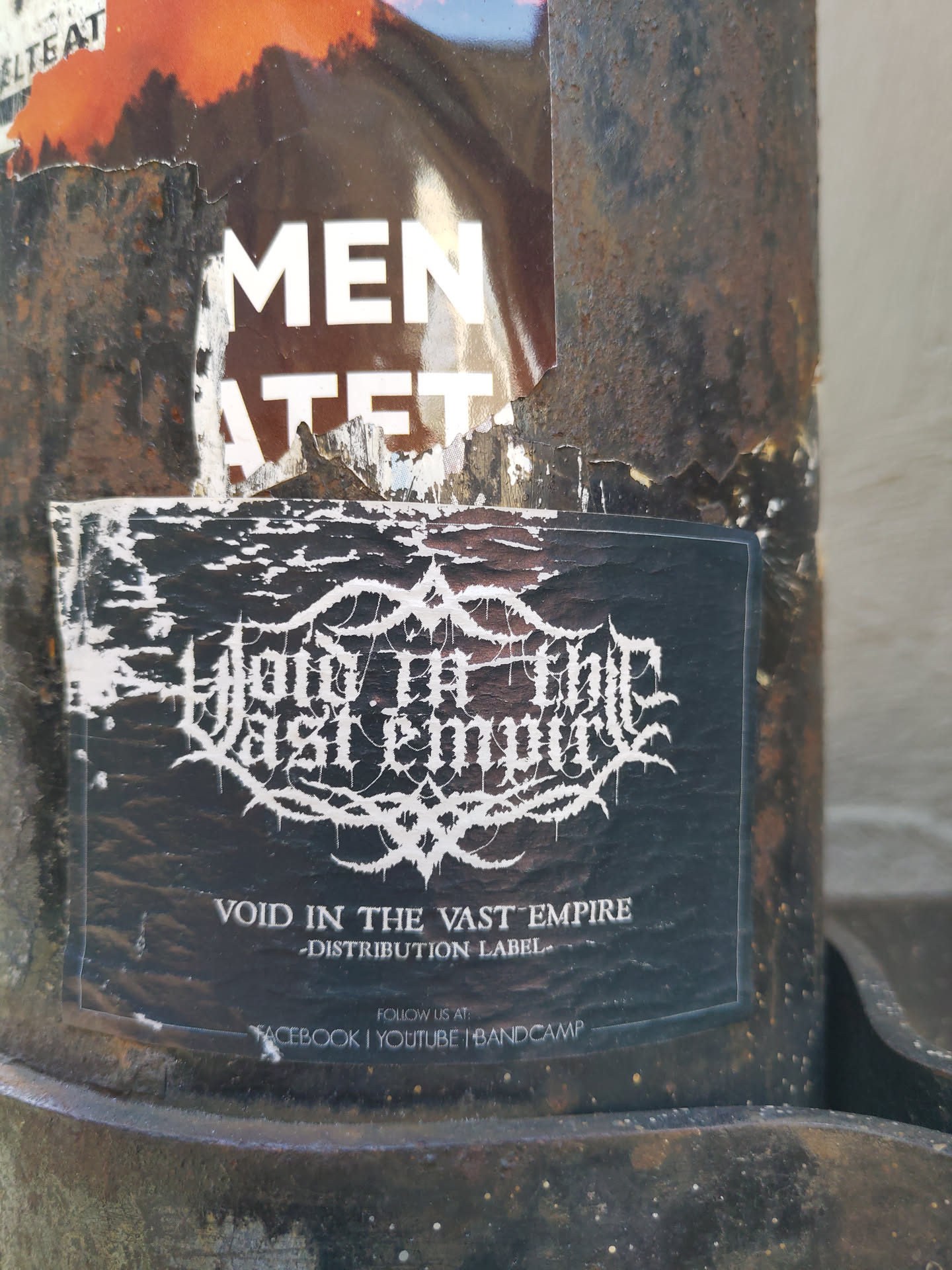 Black and white sticker with the band's logo and name.  The sticker also has social media links for Facebook, Youtube, and Bandcamp.