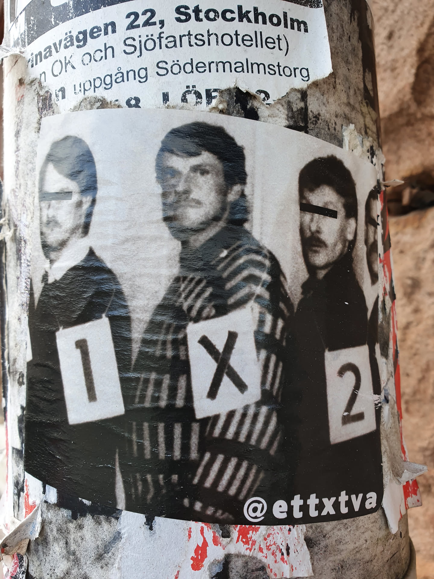 A sticker featuring a black and white photograph of three men, each with a number (1, X, 2) visible on their chest. The photo's style suggests a police lineup or a similar context. The sticker is attached to a weathered surface.  The Instagram handle @etttxtva is visible in the bottom right corner.