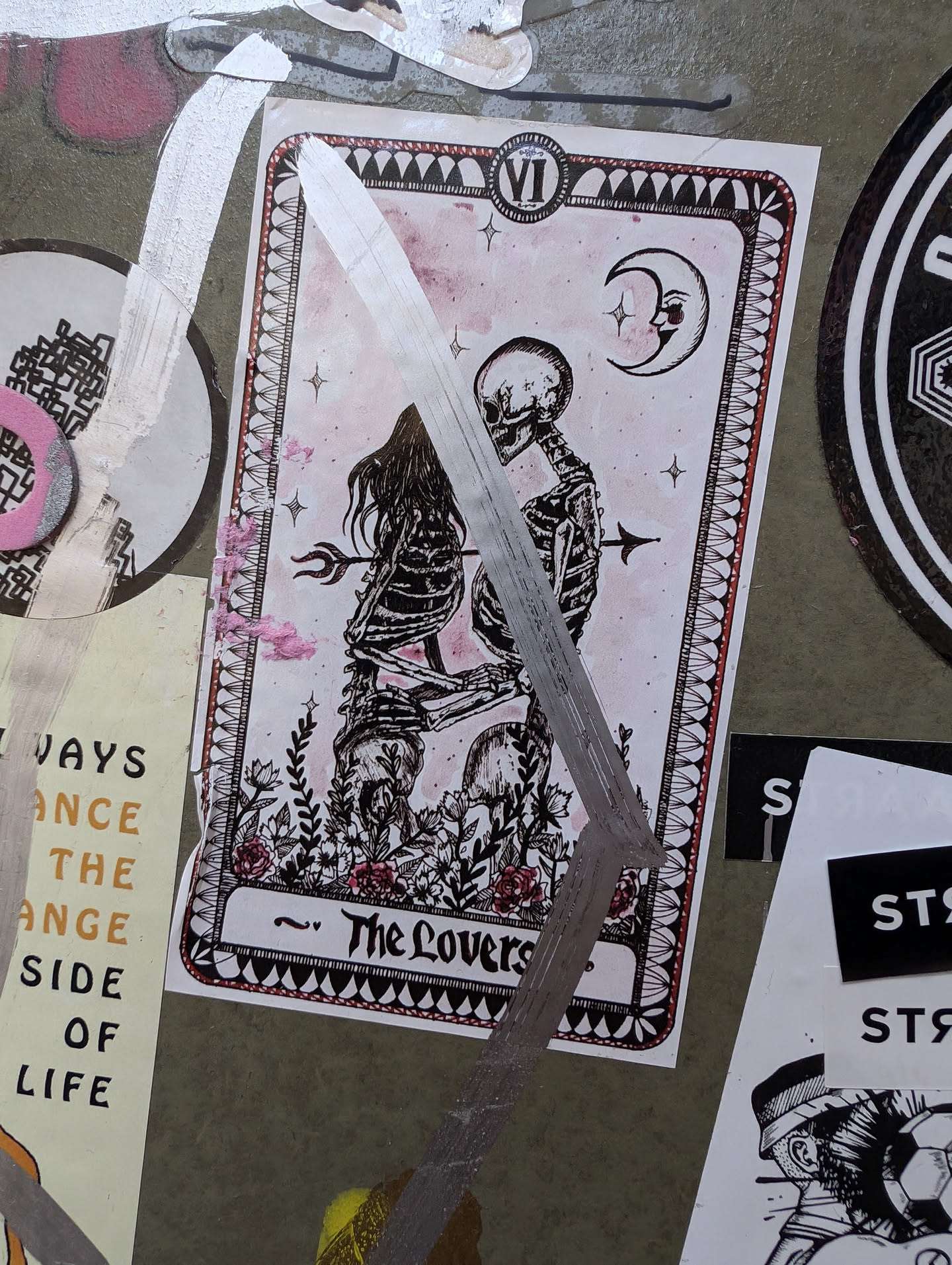 A sticker featuring an illustration of the Lovers card from the Tarot, with skeletons embracing under a crescent moon. The style is dark, romantic, and slightly macabre.