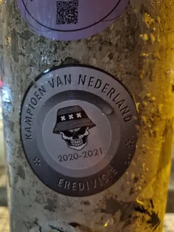A sticker commemorating the 2020-2021 Eredivisie champions of the Netherlands. It features a skull wearing a bucket hat.