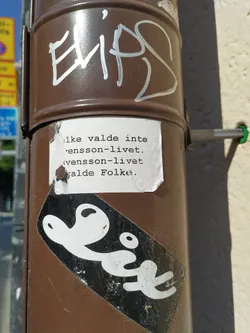 The sticker features a minimalist design with the word "Lix" written in a stylized font.  There is also a smaller piece of paper stuck on top with a message in Swedish. The message roughly translates to: "I didn't choose this life. Svensson life. The people chose."