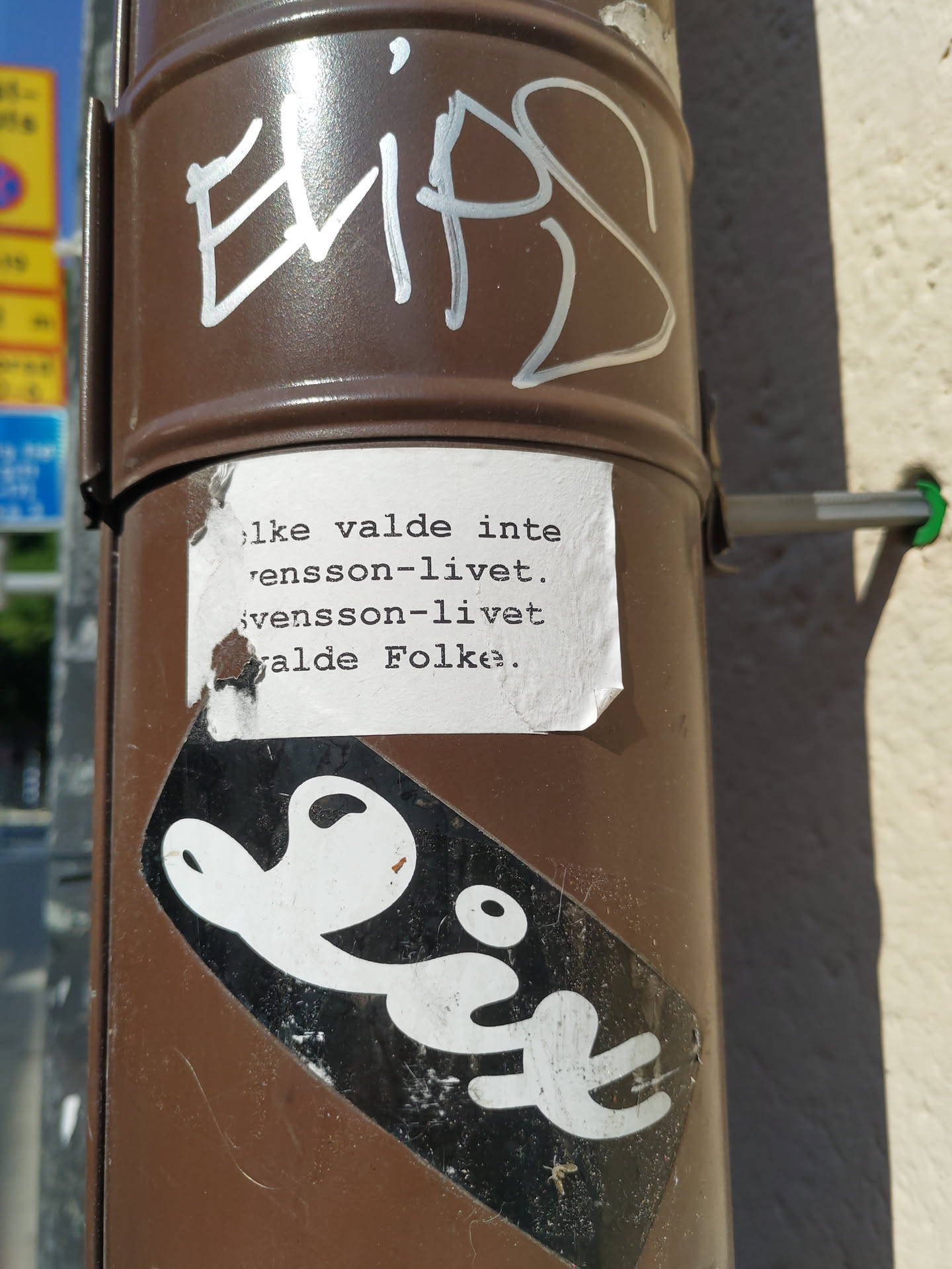The sticker features a minimalist design with the word "Lix" written in a stylized font.  There is also a smaller piece of paper stuck on top with a message in Swedish. The message roughly translates to: "I didn't choose this life. Svensson life. The people chose."